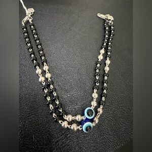 Protective eye black bead pair of anklets